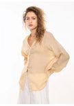 Women’s linen V-neck shirt by FJØRNA, light and breathable top with a relaxed fit, shown in a soft linen fabric.