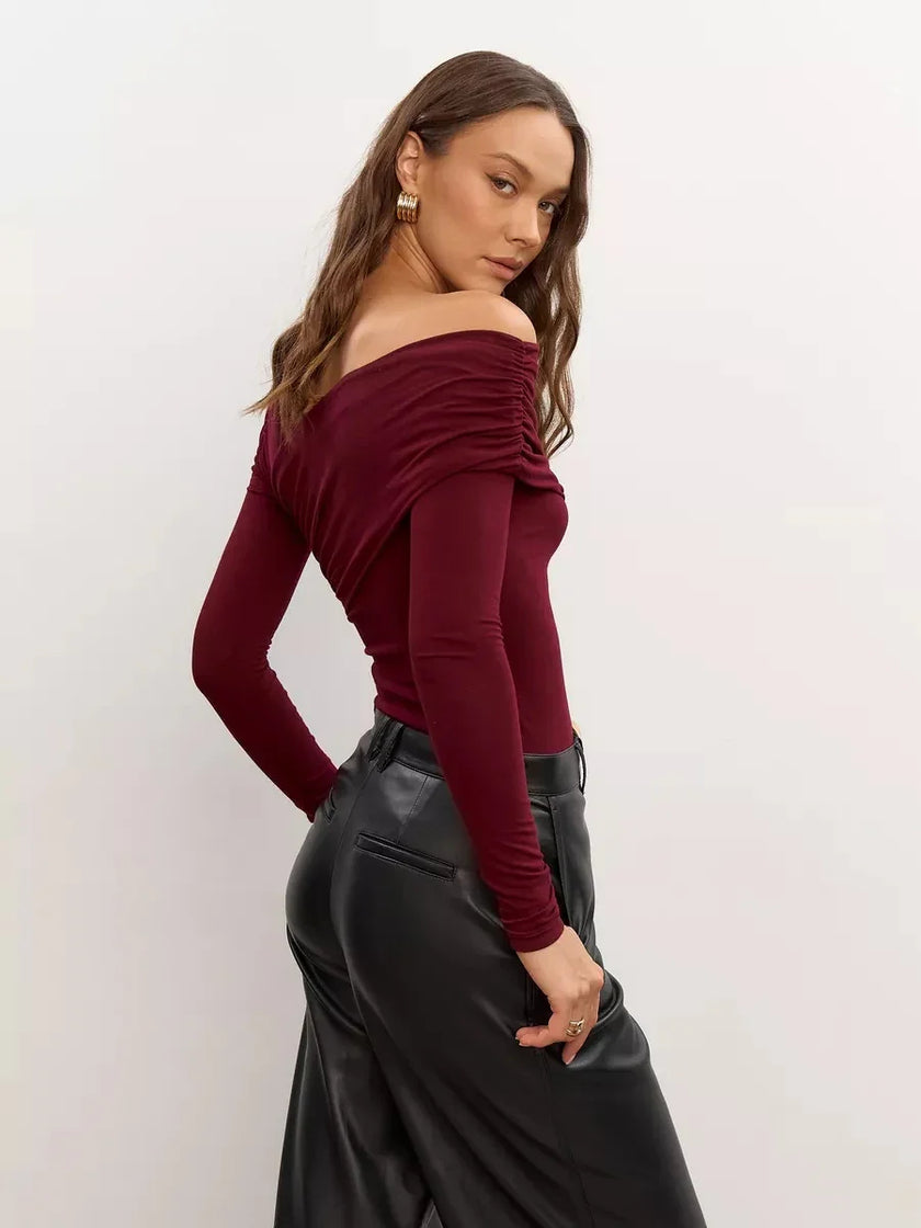 FJØRNA women's off-shoulder cotton top with a relaxed fit and short sleeves, styled on a model against a neutral background.
