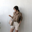 Women's linen shirt by FJØRNA with an open collar, lightweight and breathable top perfect for casual wear.