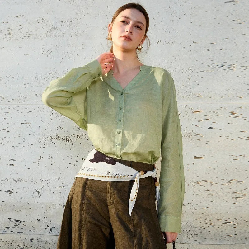 Women’s linen V-neck shirt by FJØRNA, lightweight and breathable top with a relaxed fit, shown in natural linen fabric.