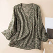 FJØRNA Kaien wrap-style blouse in soft fabric with long sleeves and a V-neck, shown on a mannequin.