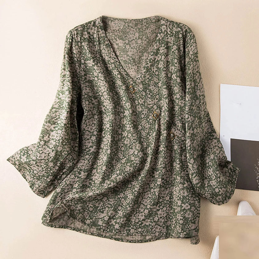 FJØRNA Kaien wrap-style blouse in soft fabric with long sleeves and a V-neck, shown on a mannequin.