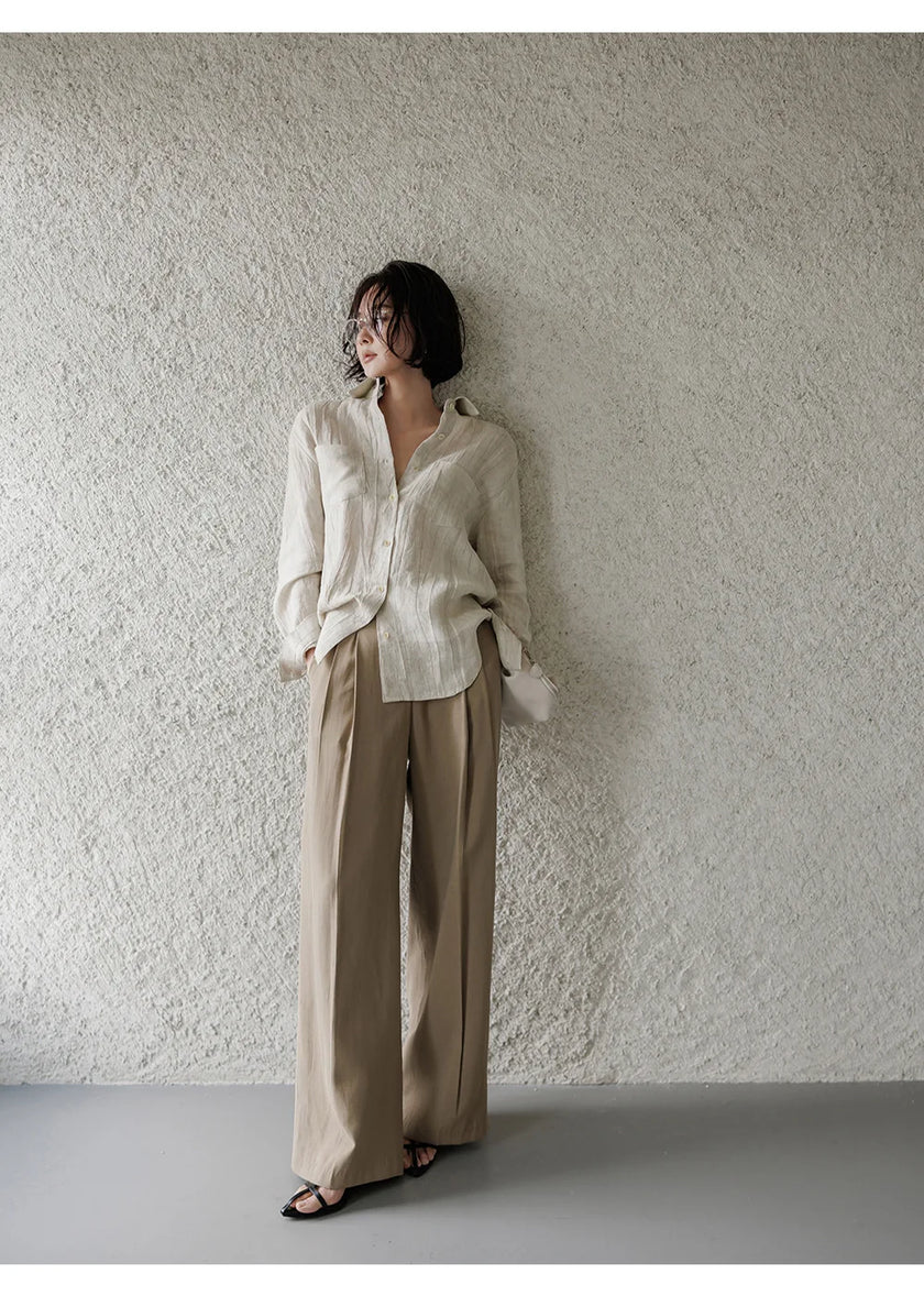 FJØRNA women's linen pleated shirt top, lightweight and breathable with a relaxed fit, shown in natural fabric detail.