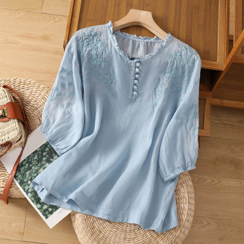 FJØRNA women's floral V-neck linen blouse with ruffle details, perfect for summer, showcasing lightweight, stylish women's top.