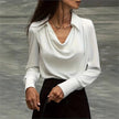 FJØRNA women's satin long sleeve shirt, elegant women's top with smooth fabric and tailored fit, shown in a stylish design.