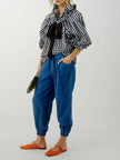 FJØRNA women's cotton blouse with ruffle detail, featuring a stylish and comfortable top with delicate ruffle accents.