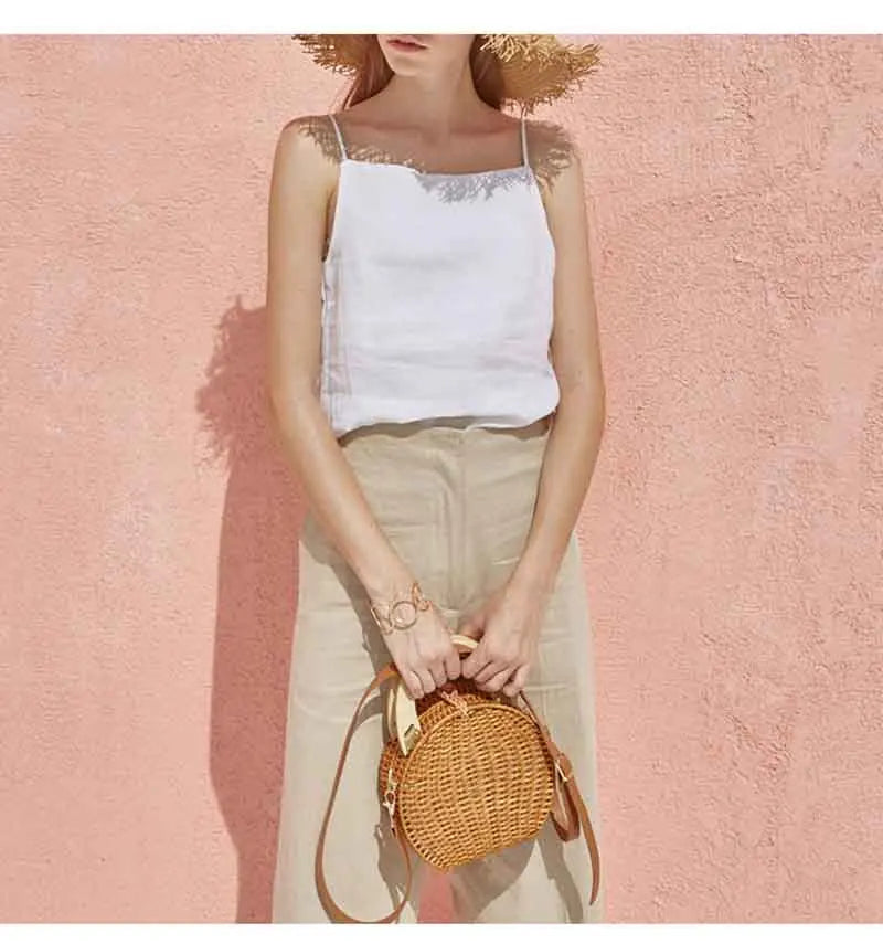 FJØRNA satin-trimmed linen cami top featuring a lightweight, breathable fabric with delicate satin accents and adjustable straps.