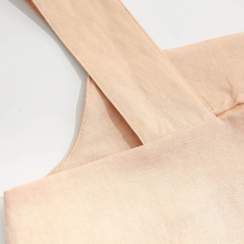 FJØRNA square neck linen cropped tank top displayed on a mannequin, showcasing its stylish design and lightweight fabric.
