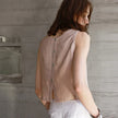 FJØRNA linen crop top for women, lightweight and breathable, featuring a relaxed fit and natural linen fabric.