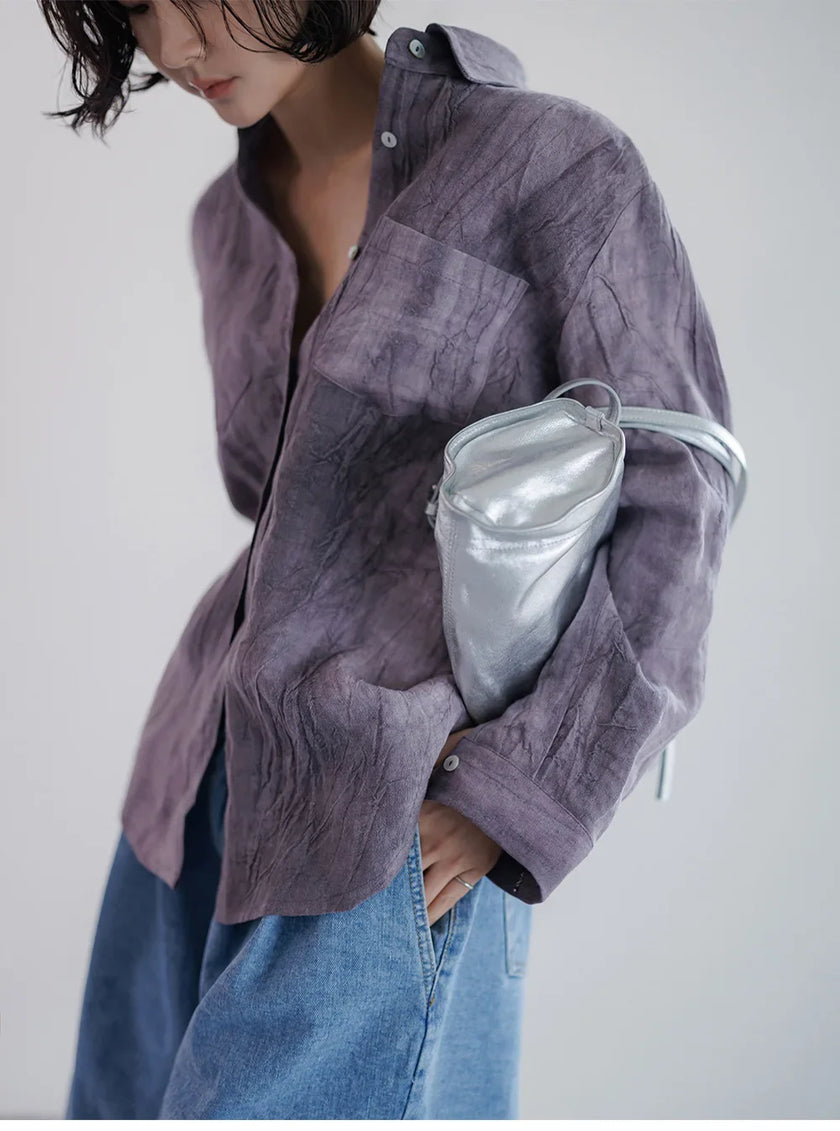 FJØRNA women's linen shirt with pleated design, lightweight top featuring a relaxed fit and natural fabric texture.