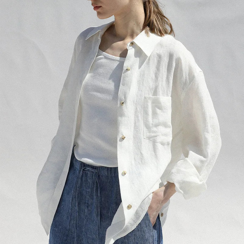 FJØRNA women's linen blouse with long sleeves, lightweight and breathable, shown in natural fabric and relaxed fit.