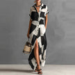 FJØRNA Victoria printed button-down maxi dress in white with floral pattern, flowing fabric, and long sleeves.