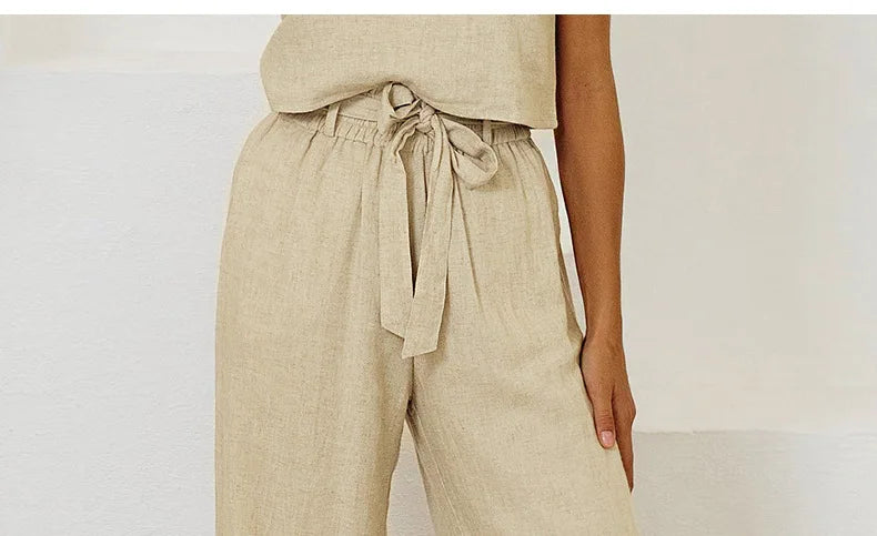 FJØRNA women's linen wide leg trousers with elastic waist and ruffle details, featuring a relaxed fit and lightweight fabric.