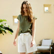 FJØRNA Petal Sleeve Linen T-Shirt in light-colored fabric, featuring elegant petal sleeve design and breathable linen material.
