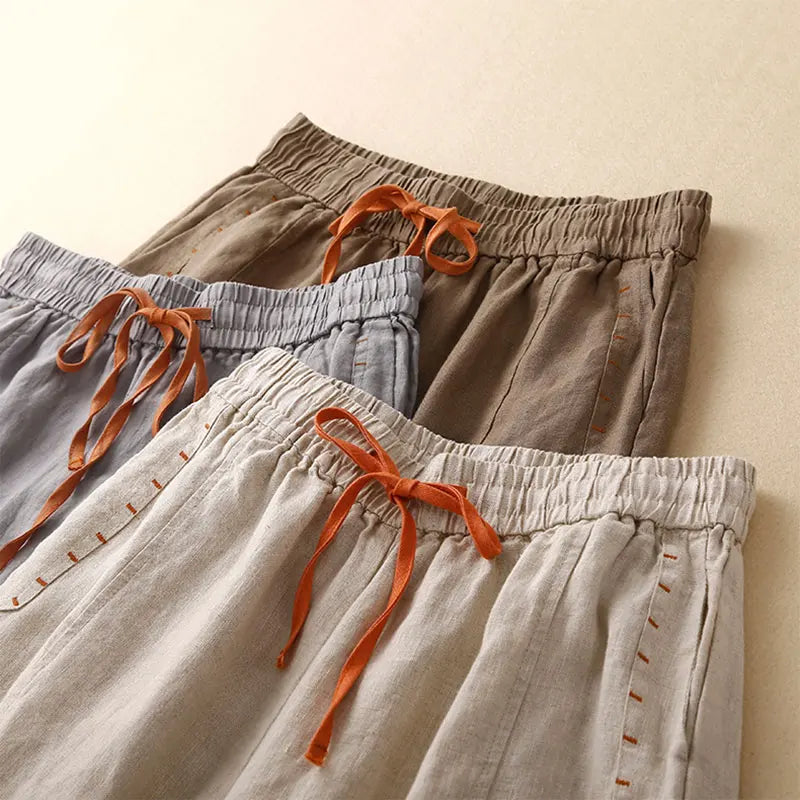 FJØRNA linen wide-leg women's trousers with drawstring waist, lightweight and comfortable for casual or stylish wear.