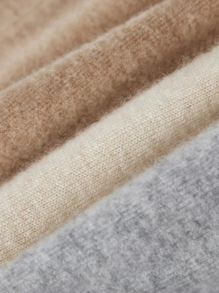 FJØRNA women's cashmere top, soft and cozy knit, featuring a classic crew neckline and long sleeves.