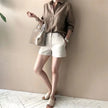 FJØRNA women's linen shirt with open collar, lightweight and breathable top, displayed on a hanger.