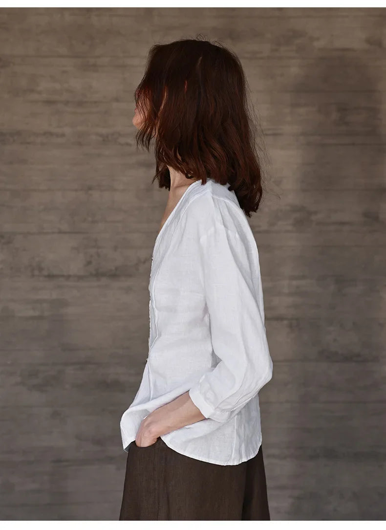 FJØRNA tailored V-neck linen top in neutral color, featuring a relaxed fit and lightweight fabric for casual summer wear