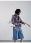FJØRNA women's linen shirt with pleated design, lightweight top featuring a relaxed fit and natural fabric texture.