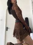 FJØRNA sheer lace mini dress showcasing delicate floral lace fabric and fitted silhouette for a stylish evening look.