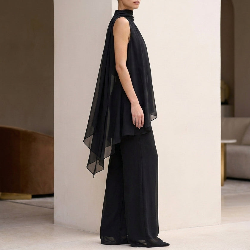 Side view of FJØRNA elegant women's two-piece chiffon pleated co-ord set, showcasing the flowing fabric and stylish design.