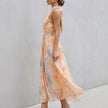 FJØRNA pleated belted A-line halter neck maxi dress shown from side view, flowing fabric and elegant design for women.