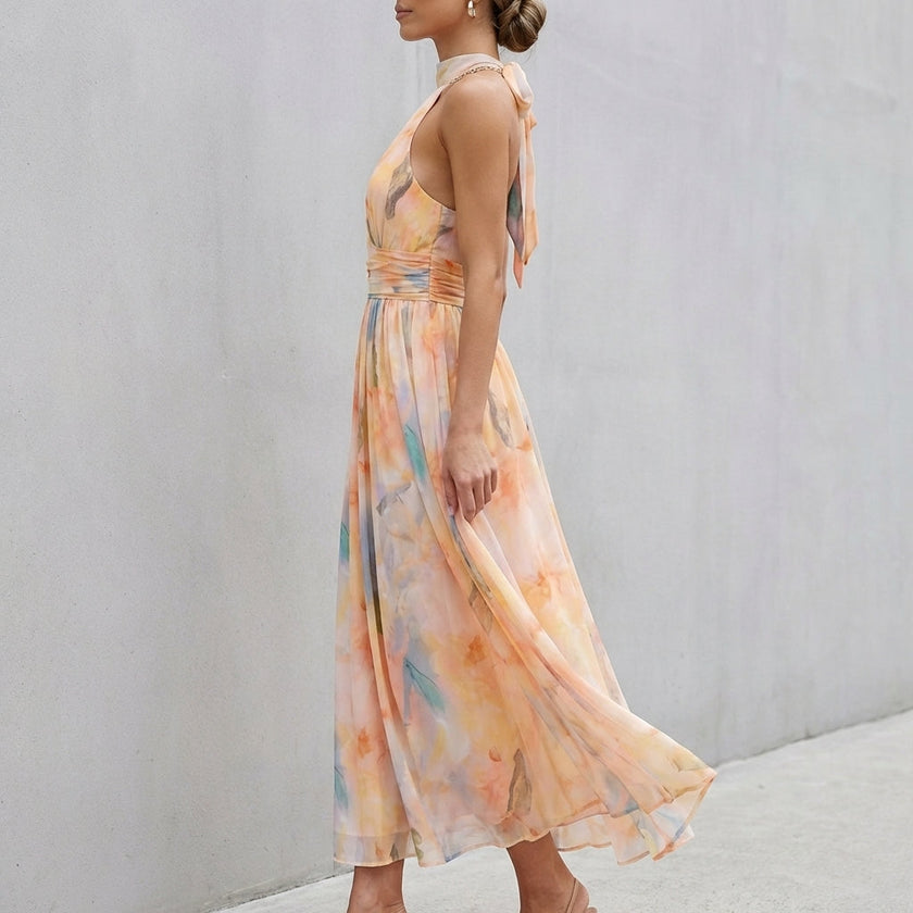 FJØRNA pleated belted A-line halter neck maxi dress shown from side view, flowing fabric and elegant design for women.