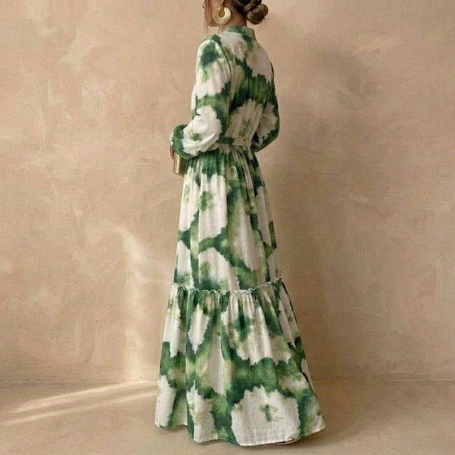 Side view of a women's elegant maxi dress by FJØRNA, featuring a V-neck and long sleeves in flowing fabric.
