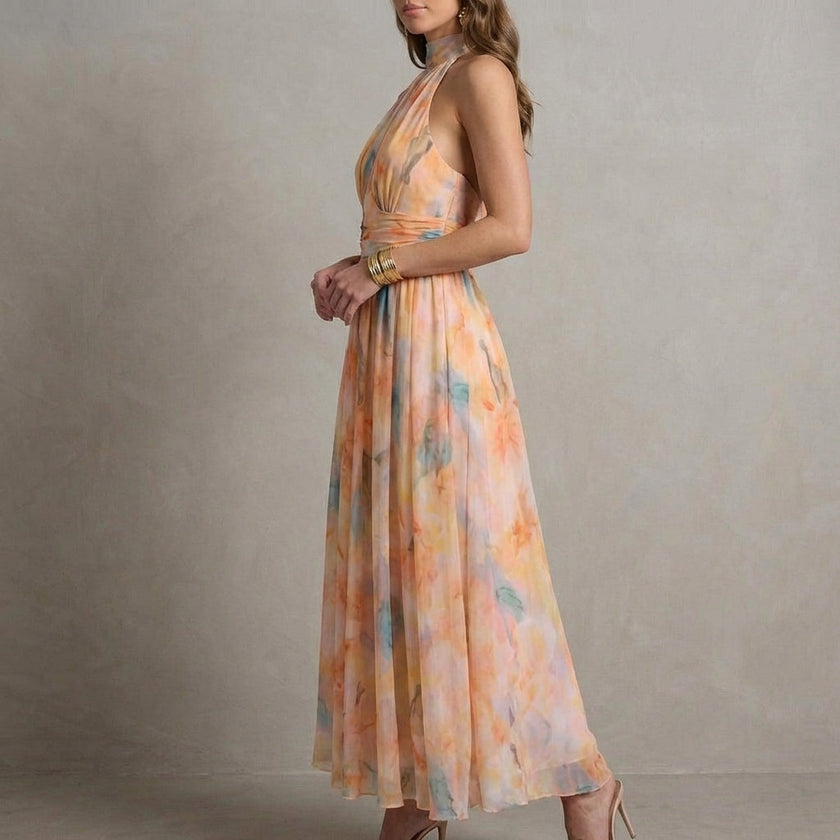 FJØRNA Ariellea flowing chiffon halter neck maxi dress with waist tie, shown from side view, elegant and lightweight for summer wear.