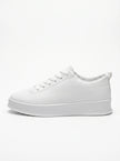 FJØRNA white men's slip-on trainers with a clean, minimalist design shown from the side profile. Casual shoe for everyday wear.