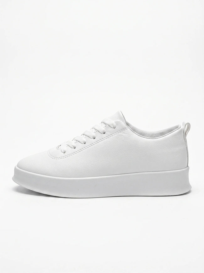 FJØRNA white men's slip-on trainers with a clean, minimalist design shown from the side profile. Casual shoe for everyday wear.