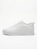 FJØRNA white men's slip-on trainers with a clean, minimalist design shown from the side profile. Casual shoe for everyday wear.
