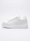 FJØRNA men's white lace-up trainers with minimalist design, side profile view showcasing sleek, casual everyday shoes for men.