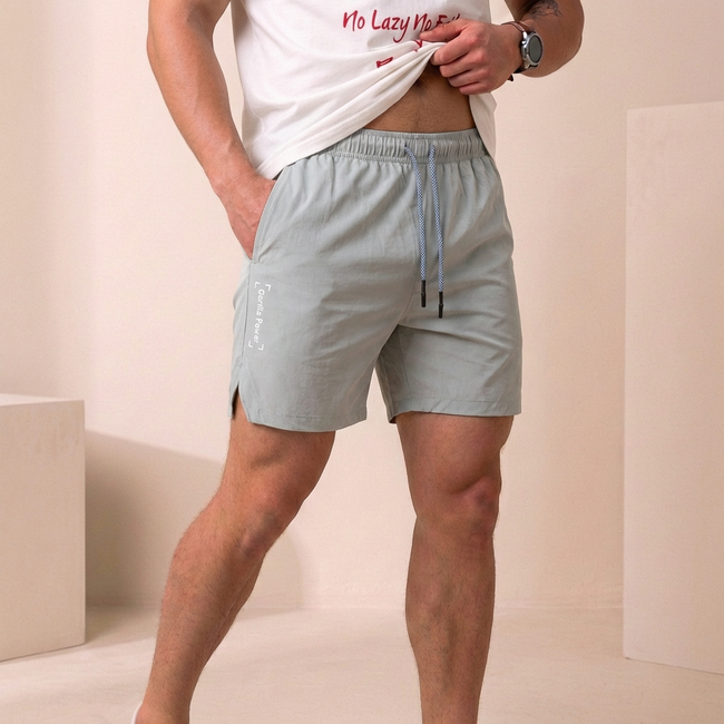 Sky blue men's swim shorts by FJØRNA with relaxed fit, side pockets, slit hem, and quick-dry fabric.