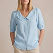 Sky blue FJØRNA women's summer puff sleeve linen blouse with button front, casual and stylish top for warm weather.
