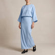 Sky blue FJØRNA two-piece woven skirt suit with textured fabric and draped high-waist silhouette, perfect for stylish formal wear.