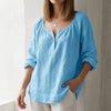 Sky blue V-neck linen summer blouse for women by FJØRNA, lightweight, flowy, and perfect for warm weather.