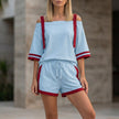 Sky blue FJØRNA sporty two-piece set with contrast trim, relaxed off-shoulder top and matching shorts, casual and stylish.