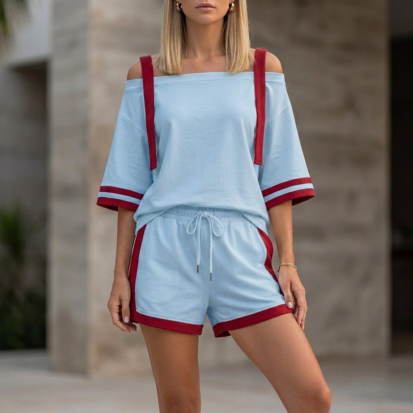 Sky blue FJØRNA sporty two-piece set with contrast trim, relaxed off-shoulder top and matching shorts, casual and stylish.