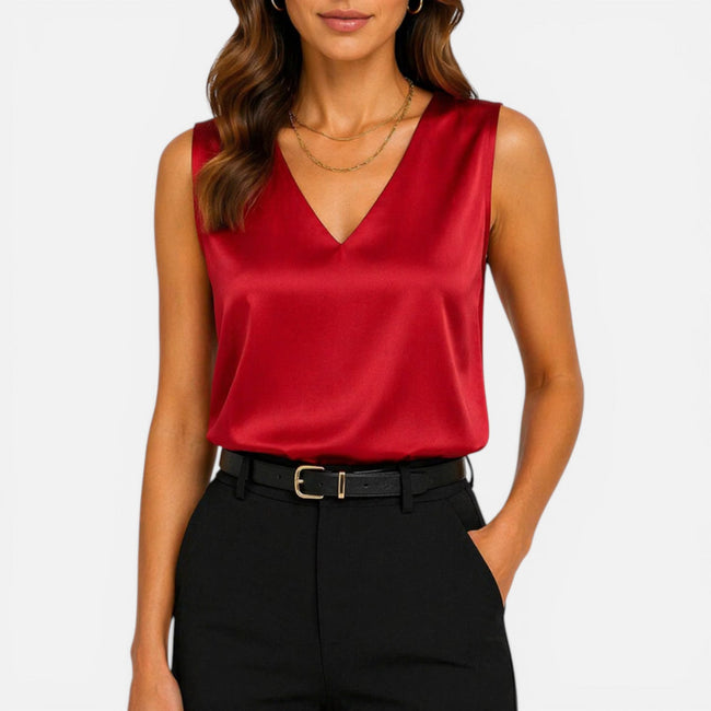 Women's sleeveless satin blouse with V-neck by FJØRNA, featuring an elegant silky, smooth fabric perfect for stylish occasions.