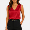 Women's sleeveless satin blouse with V-neck by FJØRNA, featuring an elegant silky, smooth fabric perfect for stylish occasions.
