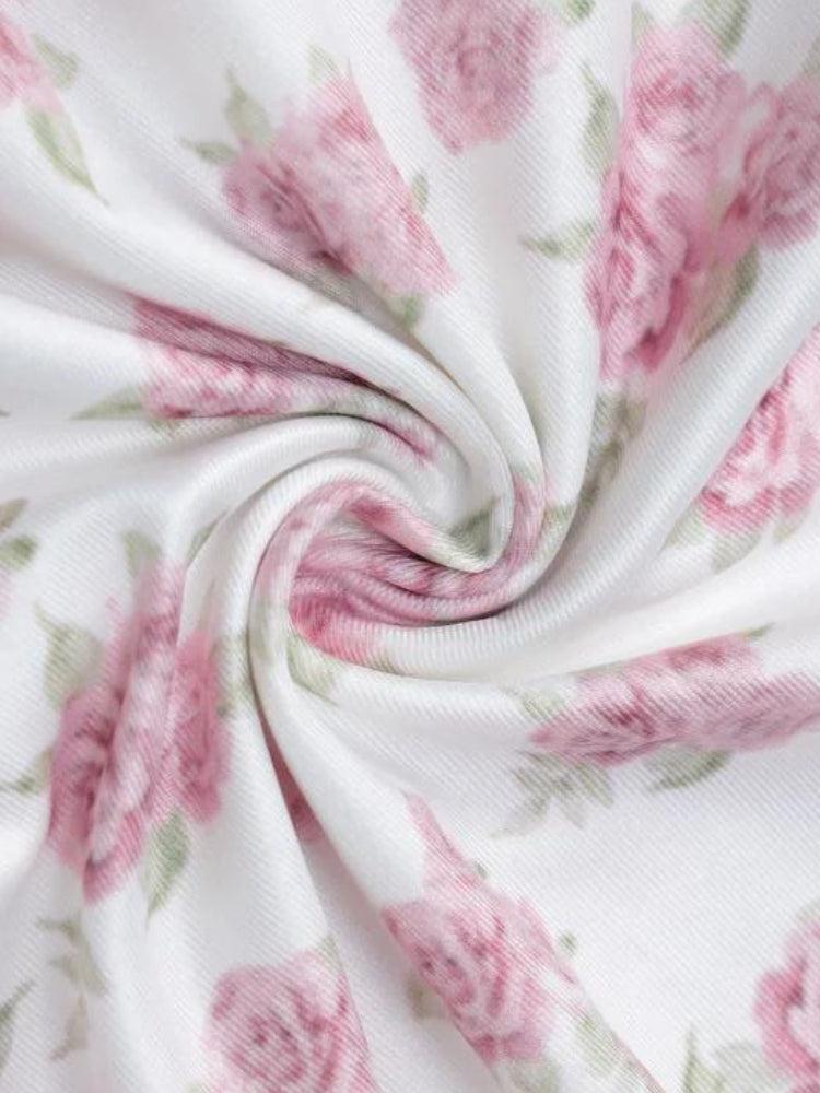 White floral tube mini dress by FJØRNA featuring a soft girl style, shown on a model with a fitted silhouette.