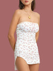 FJØRNA soft girl floral tube mini dress in white, featuring a fitted bodice and delicate floral pattern on smooth fabric.