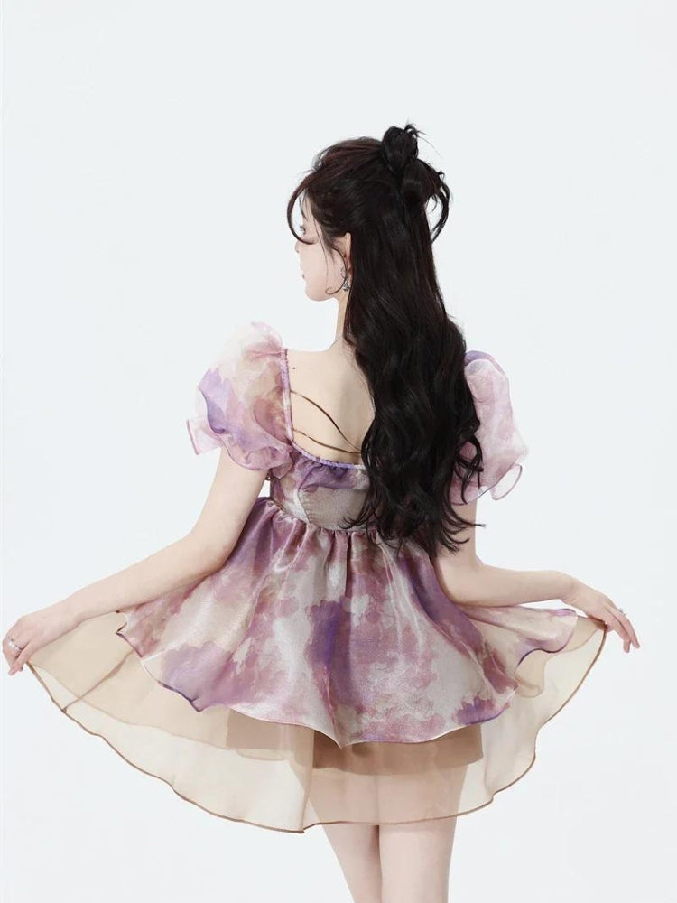 White soft girl puff sleeve layered mini dress by FJØRNA, featuring a feminine design with puffy sleeves and a layered skirt.