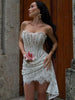 FJØRNA strapless lace mini dress featuring a fitted bodice and flared skirt, perfect for party or daytime occasions.