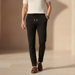 FJØRNA men's black stretch sports pants, slim fit athletic trousers with elastic waistband and modern design.