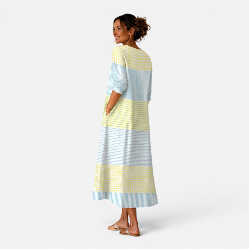 Women's breathable striped midi dress by FJØRNA, lightweight summer fit, flowing design ideal for warm weather.