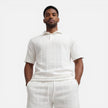 Men's breathable summer knit polo shorts set by FJØRNA, featuring a structured design and comfortable fit for warm weather.