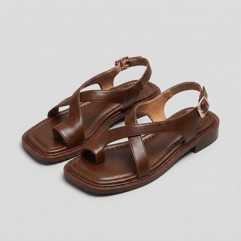 FJØRNA women's square toe block heel criss-cross sandals displayed on studio background, featuring stylish design and open toe style.