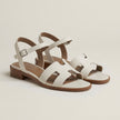 FJØRNA ankle-length flat sandals with ankle strap and buckle, stylish open-toe footwear in a studio setting